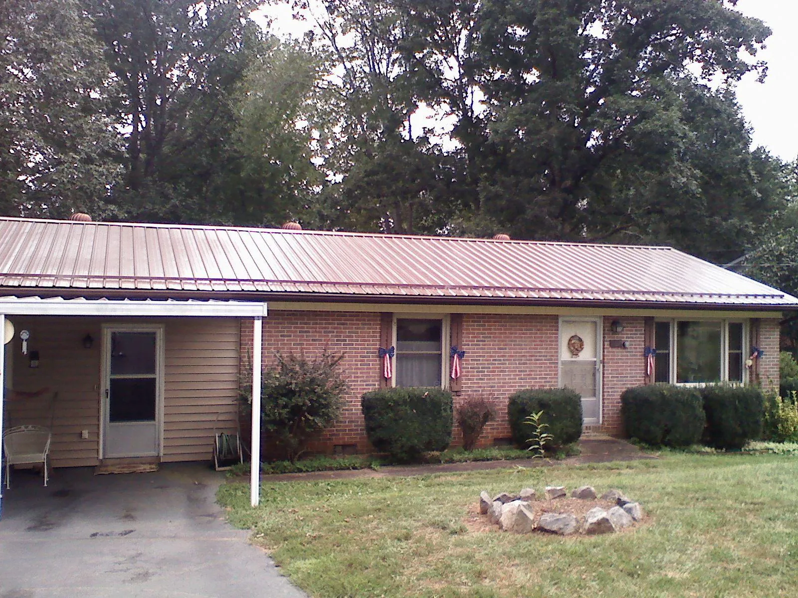 Bronze metal roof and carport on a brick ranch home — Roof Repair work by our crew in La Plata