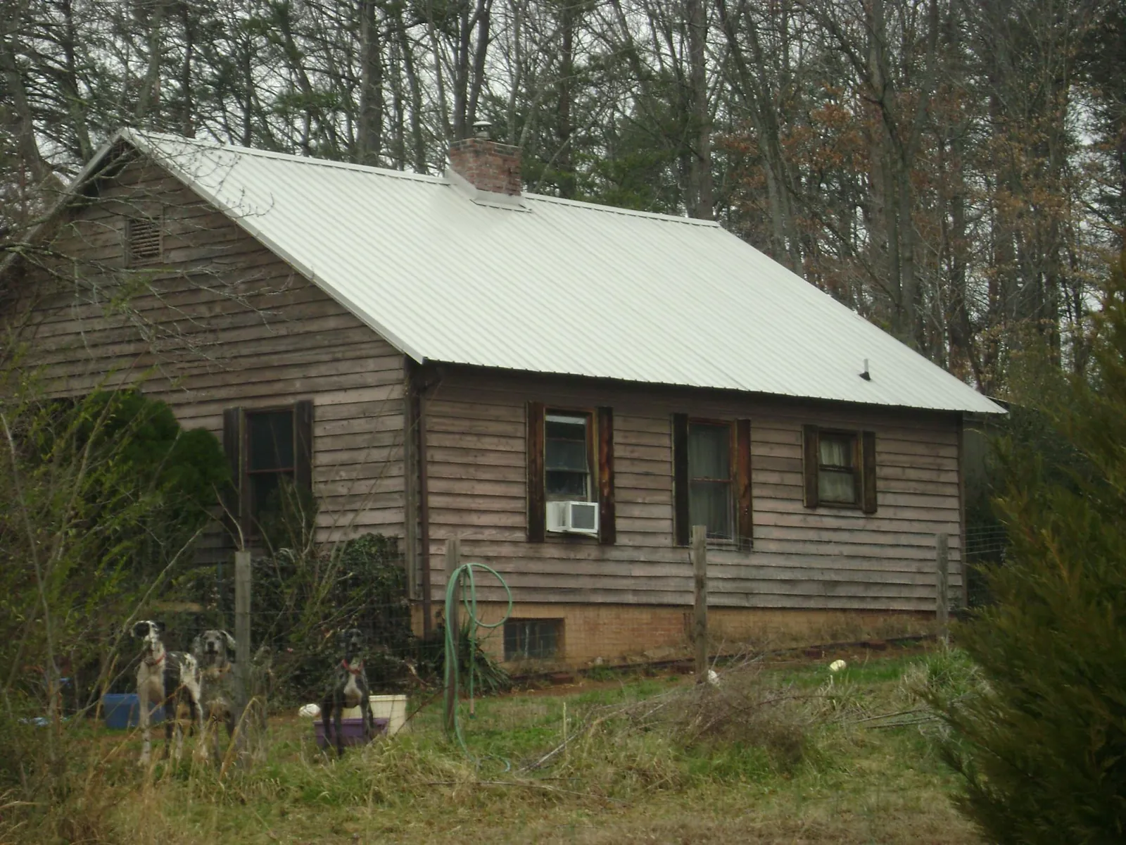 White metal roof on an old wood sided farmhouse, from a Metal Roof Installation job in La Plata